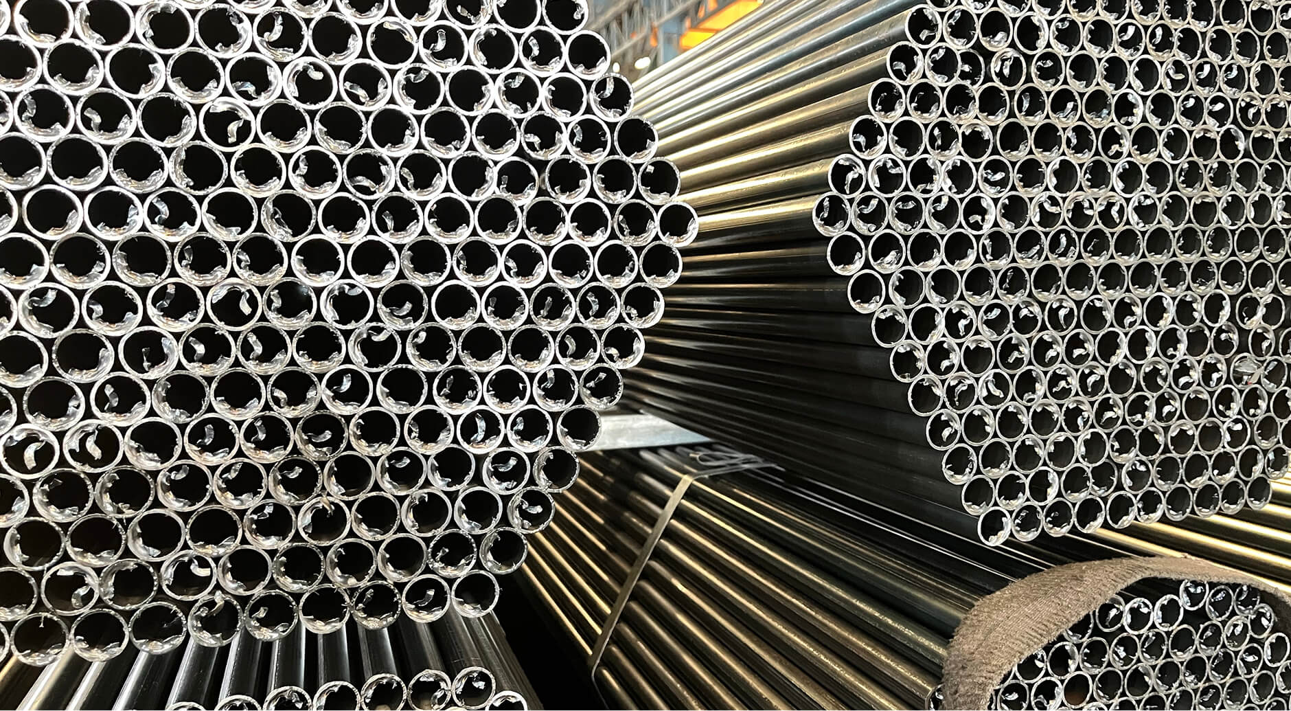 Tightly bundled seamless steel tubing in multiple diameters demonstrating size range from small to large bore